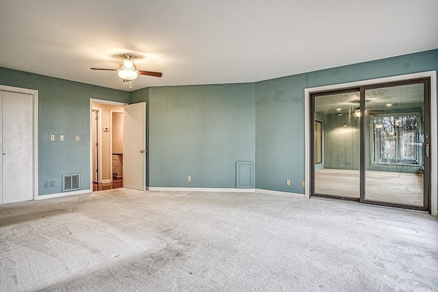 spare room featuring carpet flooring and ceiling fan