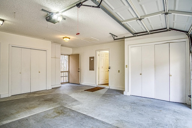 garage with a garage door opener and electric panel