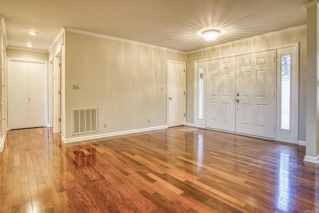 entrance foyer featuring ornamental molding and wood-type flooring