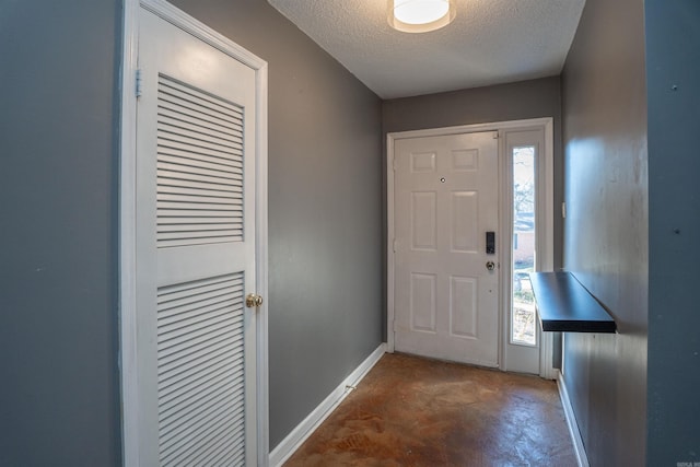 foyer entrance featuring a textured ceiling