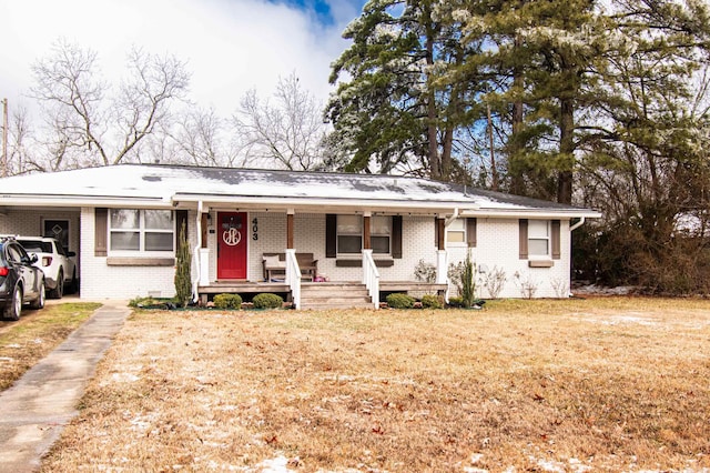 single story home with a porch and a front yard