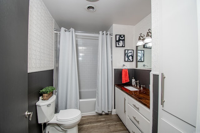 full bathroom with toilet, shower / tub combo, vanity, and hardwood / wood-style floors