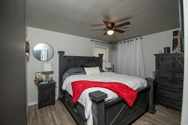 bedroom with ceiling fan and hardwood / wood-style flooring