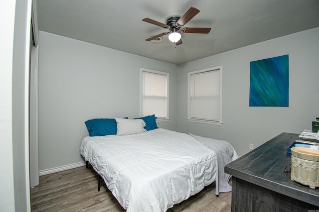 bedroom with ceiling fan and hardwood / wood-style flooring