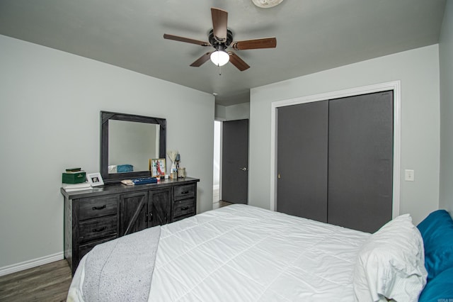 bedroom with ceiling fan, a closet, and dark hardwood / wood-style floors