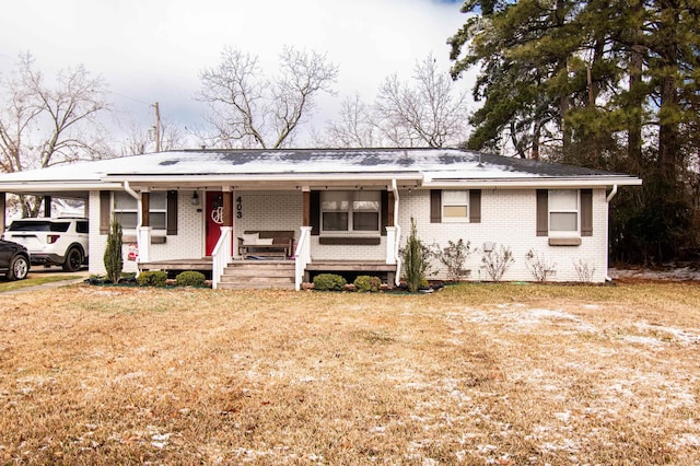 ranch-style home with a front yard, a porch, and a carport