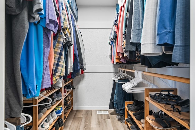 spacious closet with hardwood / wood-style floors