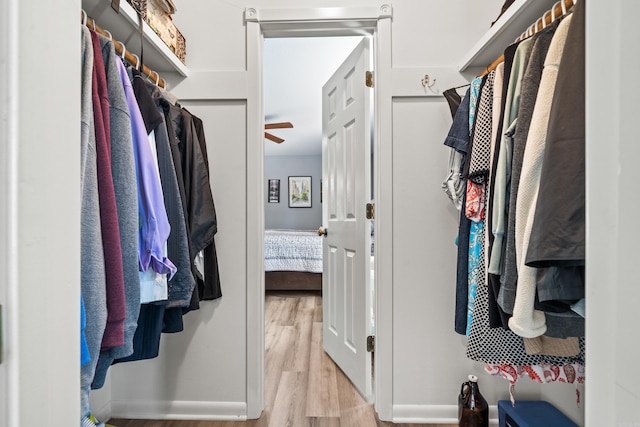 spacious closet with light wood-type flooring and ceiling fan