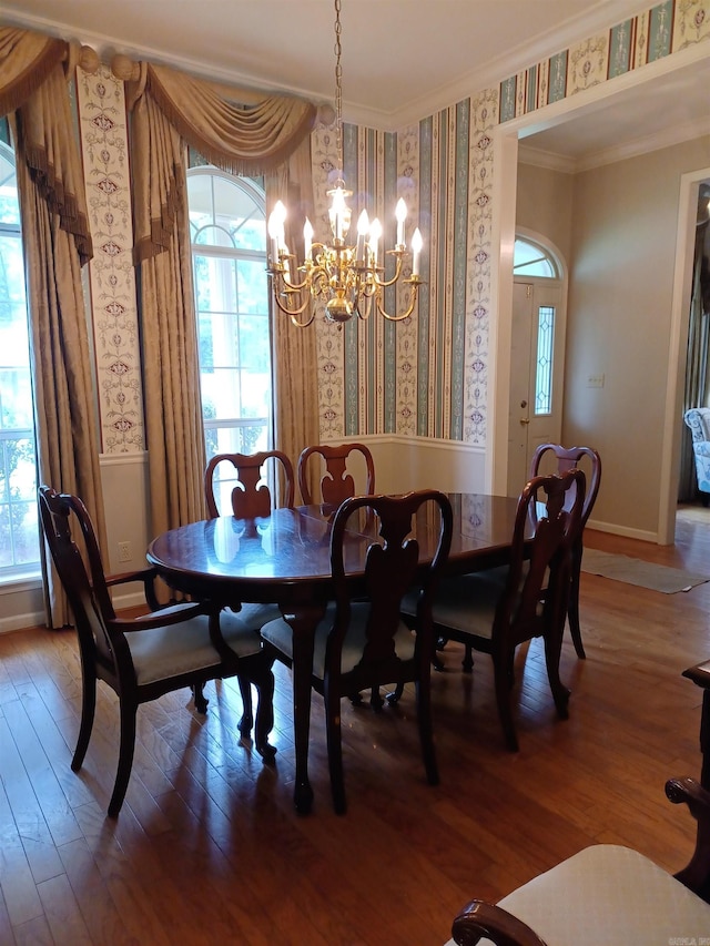 dining room featuring ornamental molding, a notable chandelier, and wood-type flooring