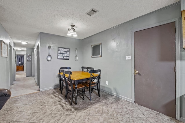 dining space with a textured ceiling