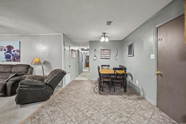 tiled dining space featuring a textured ceiling