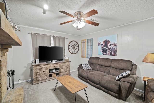 carpeted living room featuring ornamental molding, ceiling fan, and a textured ceiling