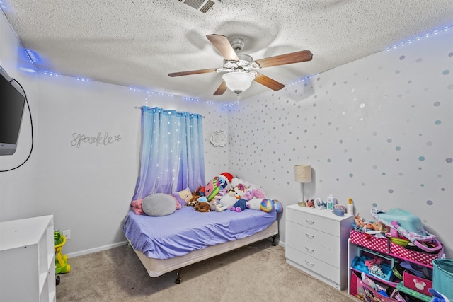 bedroom with light carpet, ceiling fan, and a textured ceiling