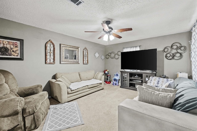 carpeted living room featuring a textured ceiling and ceiling fan