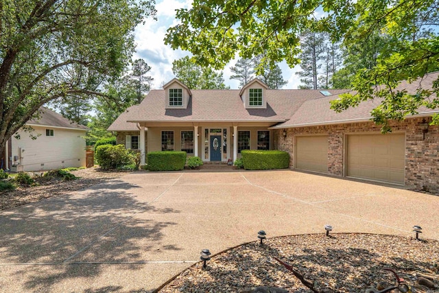 cape cod home with a garage