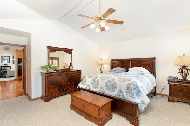 bedroom with lofted ceiling, ceiling fan, and light carpet