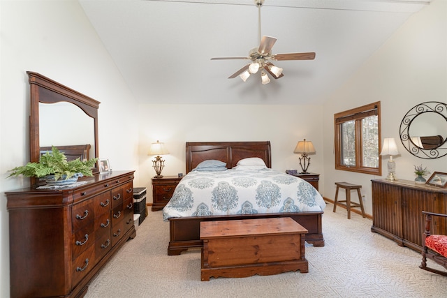 bedroom with ceiling fan, light colored carpet, and vaulted ceiling