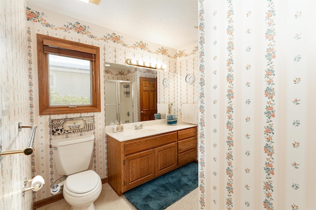 bathroom with toilet, vanity, a textured ceiling, and a shower with shower door