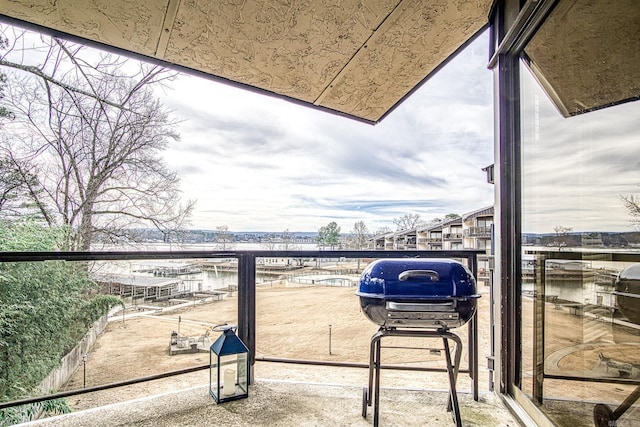 balcony featuring grilling area and a water view