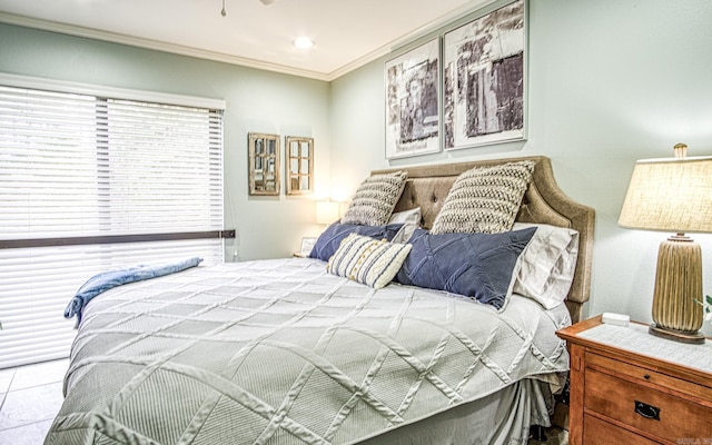 bedroom with light tile patterned flooring and crown molding