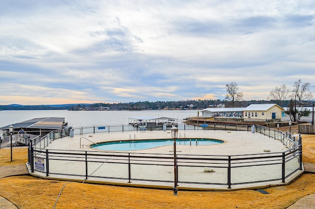 view of swimming pool featuring a water view