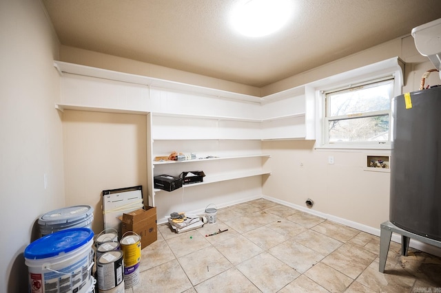 laundry room with water heater, hookup for an electric dryer, light tile patterned floors, and washer hookup