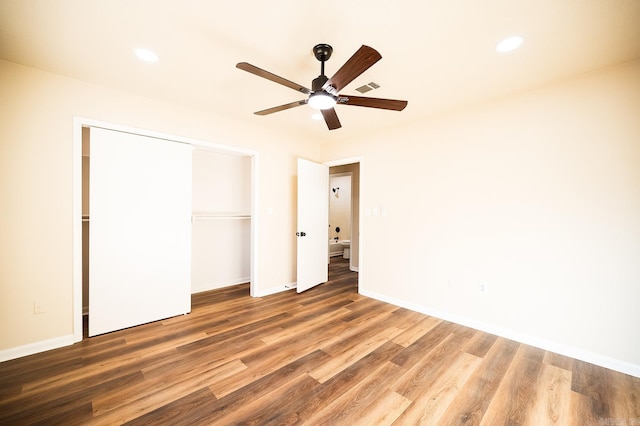 unfurnished bedroom with a closet, ceiling fan, and hardwood / wood-style flooring