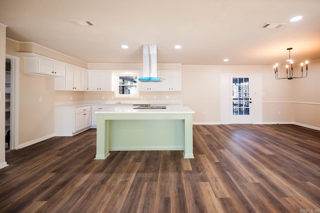 kitchen featuring white cabinetry, dark wood-type flooring, island range hood, and a center island