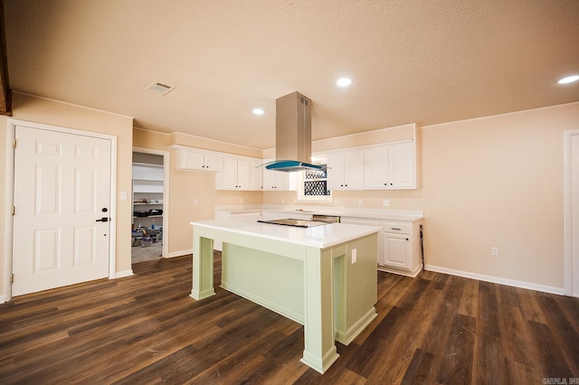 kitchen with white cabinetry, a center island, island exhaust hood, dark hardwood / wood-style flooring, and a breakfast bar