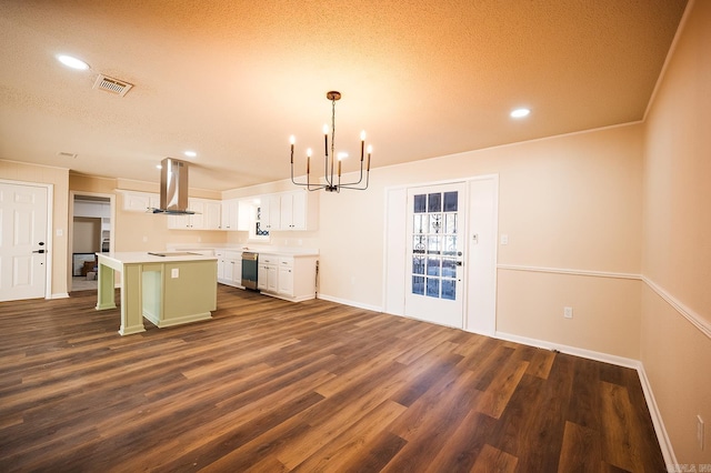 kitchen featuring white cabinets, island exhaust hood, hanging light fixtures, a kitchen island, and a breakfast bar