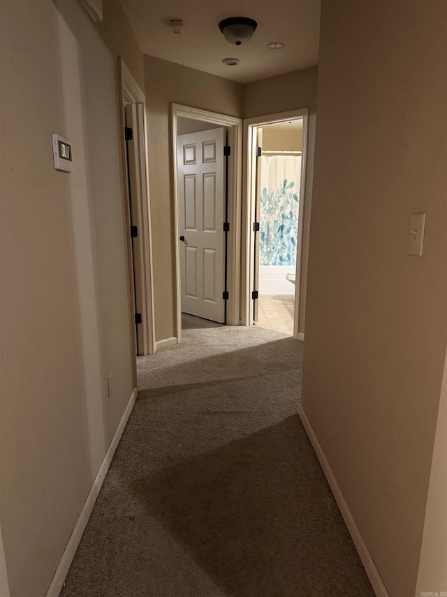 corridor featuring light colored carpet