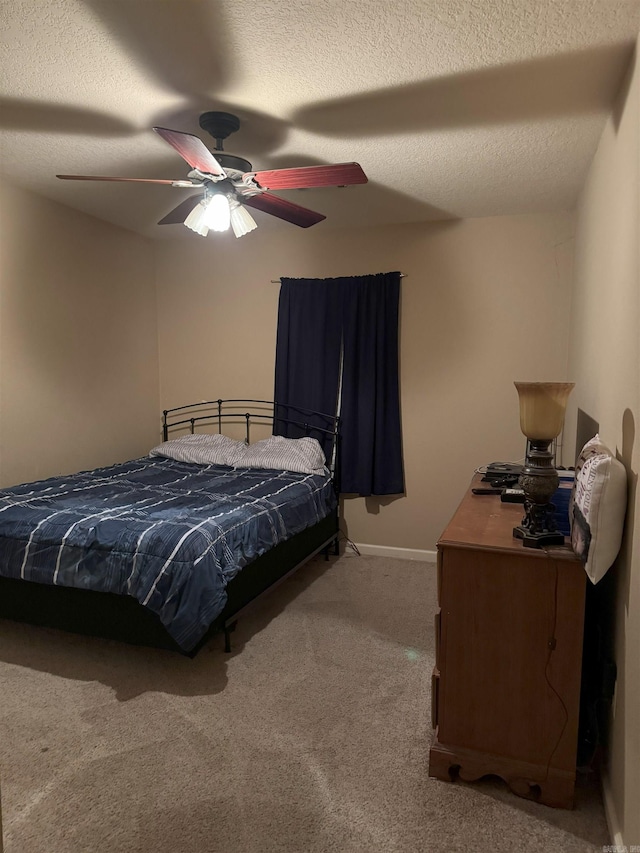 carpeted bedroom featuring a textured ceiling and ceiling fan