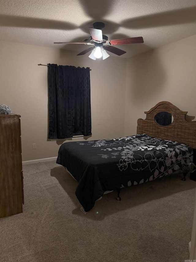 carpeted bedroom featuring a textured ceiling and ceiling fan