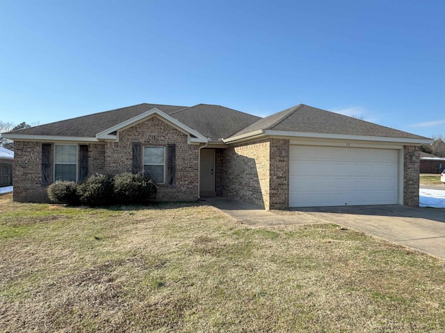 ranch-style home featuring a front lawn and a garage