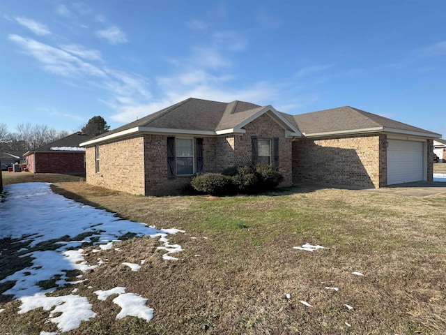 view of front of property with a garage and a yard