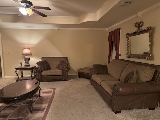 living room with ceiling fan, crown molding, light carpet, and a tray ceiling