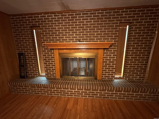 room details with a brick fireplace and hardwood / wood-style floors