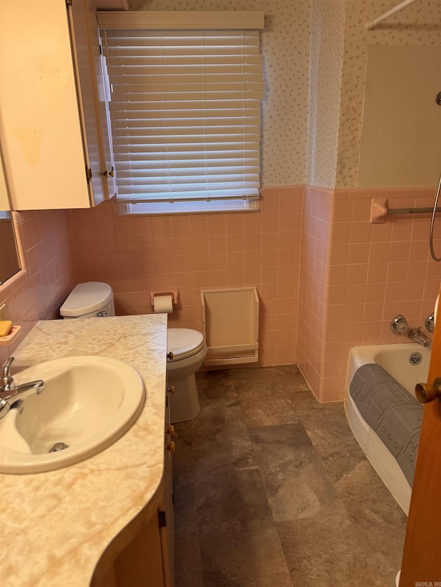 full bathroom featuring tile walls, shower / tub combination, vanity, and toilet