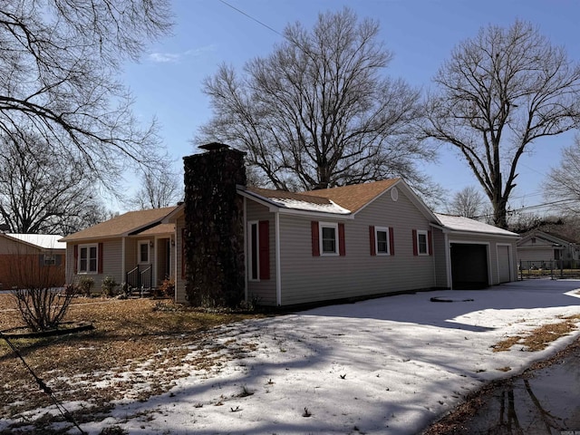 snow covered property featuring a garage