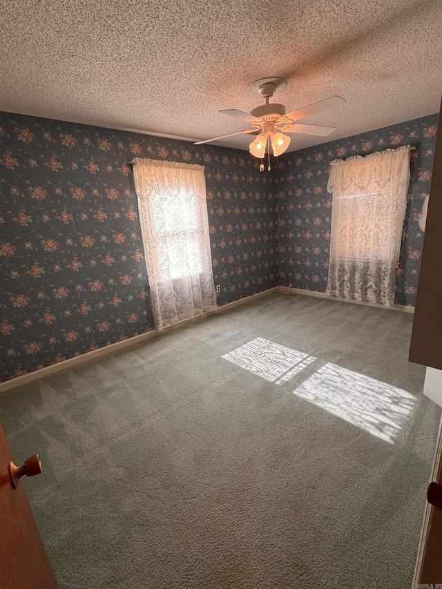 carpeted empty room with a textured ceiling