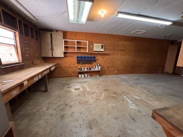 basement with wood walls and a workshop area