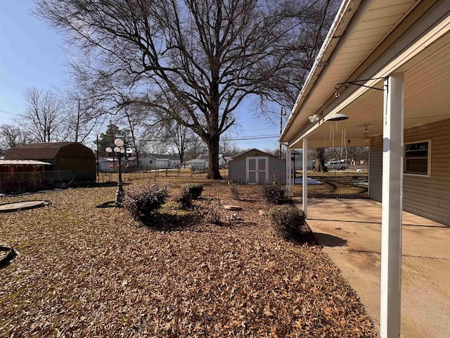 view of yard featuring a patio area and a shed