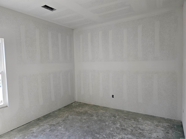 spare room with concrete floors