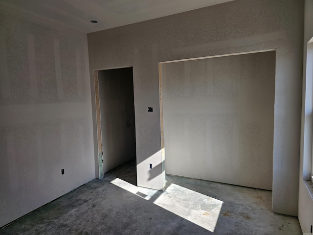 spare room with concrete floors