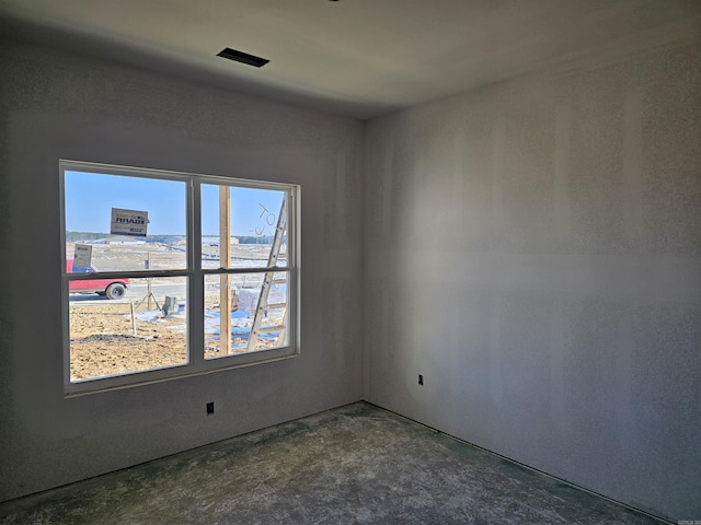 unfurnished room featuring concrete flooring