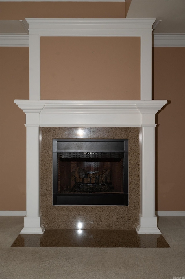 details featuring a fireplace, ornamental molding, and carpet