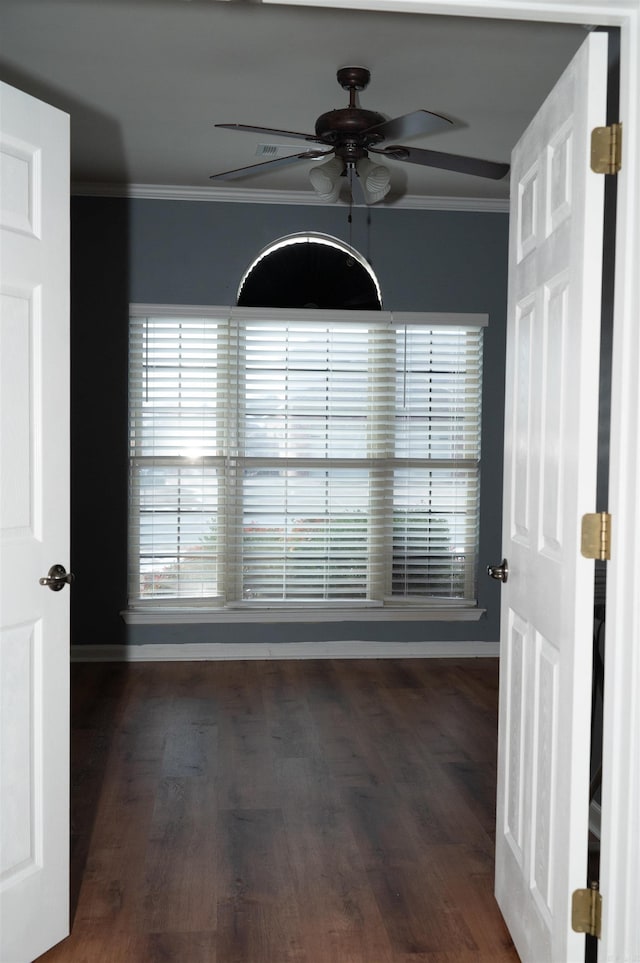 unfurnished room with ceiling fan, crown molding, and dark hardwood / wood-style floors