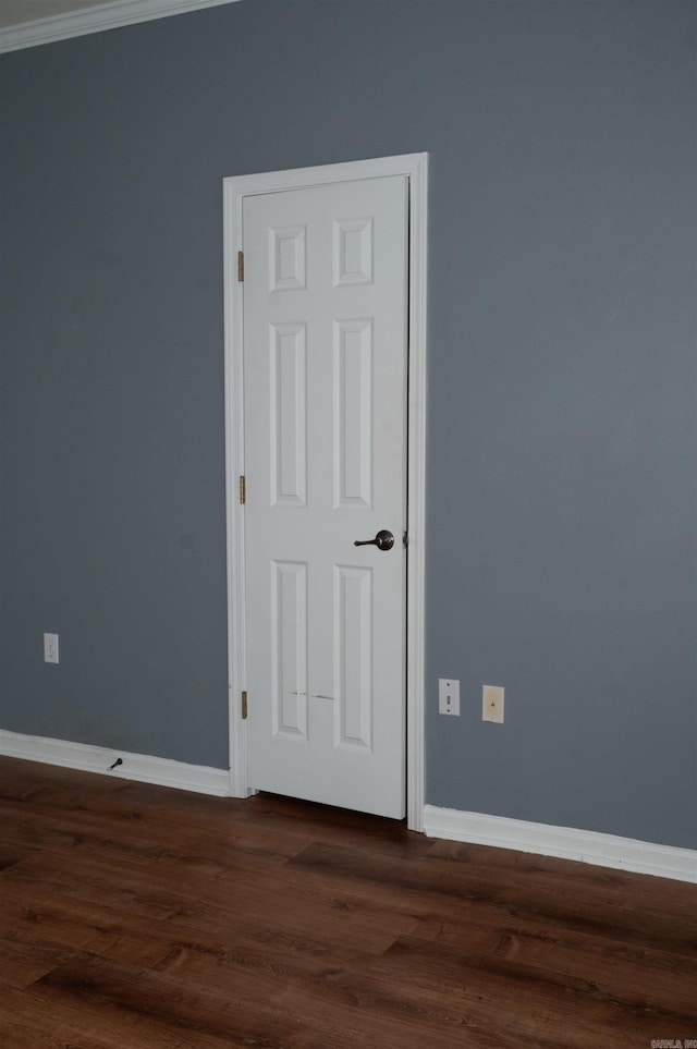 unfurnished room featuring crown molding and dark hardwood / wood-style flooring