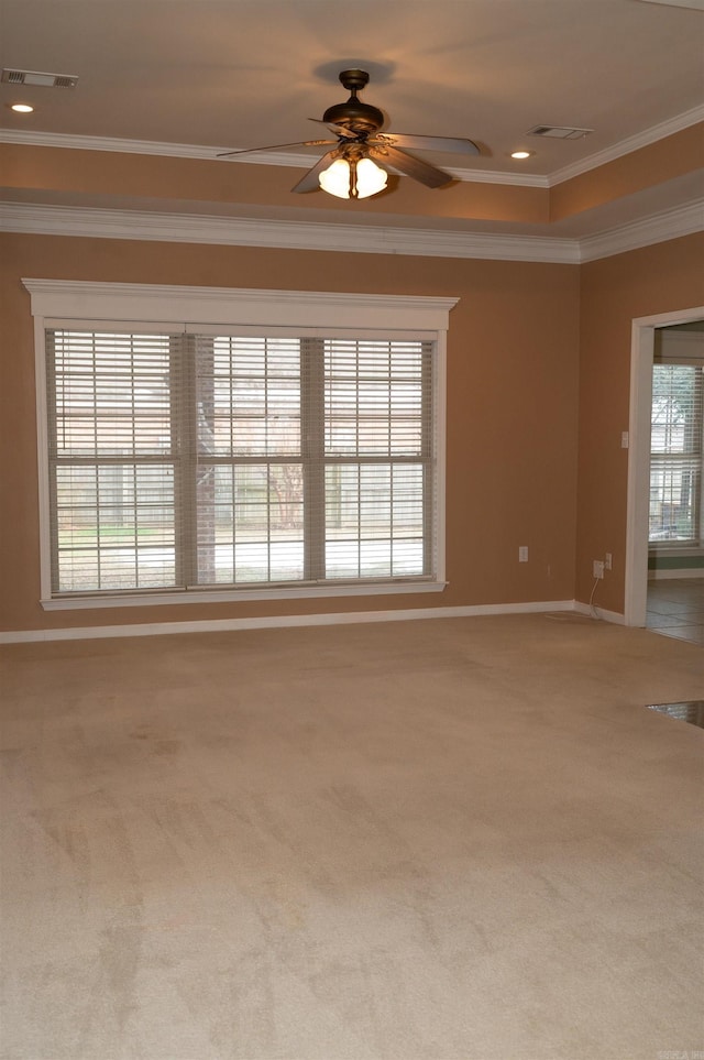 empty room with ornamental molding, ceiling fan, and carpet floors