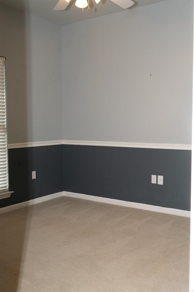 carpeted spare room with ceiling fan